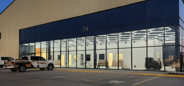 Modern retail building with large glass facade with hexagon LED lights