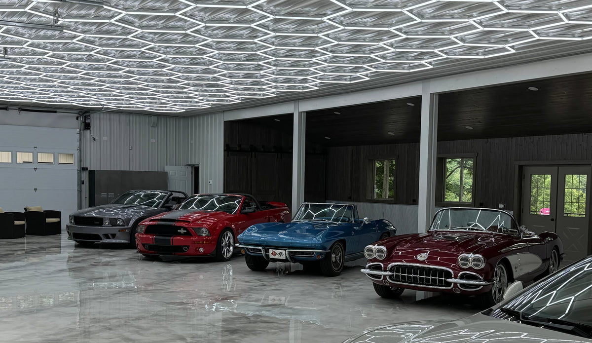 Dimmable hexagon lights over a row of classic cars in a large garage; low voltage 24V with remote control