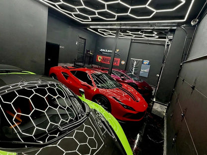 Hexagon LED showroom ceiling over sports cars; dimmable low voltage hex lights with remote