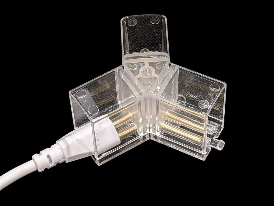 Clear-shroud 3-way hexagon light connector showing straight brass contact pins