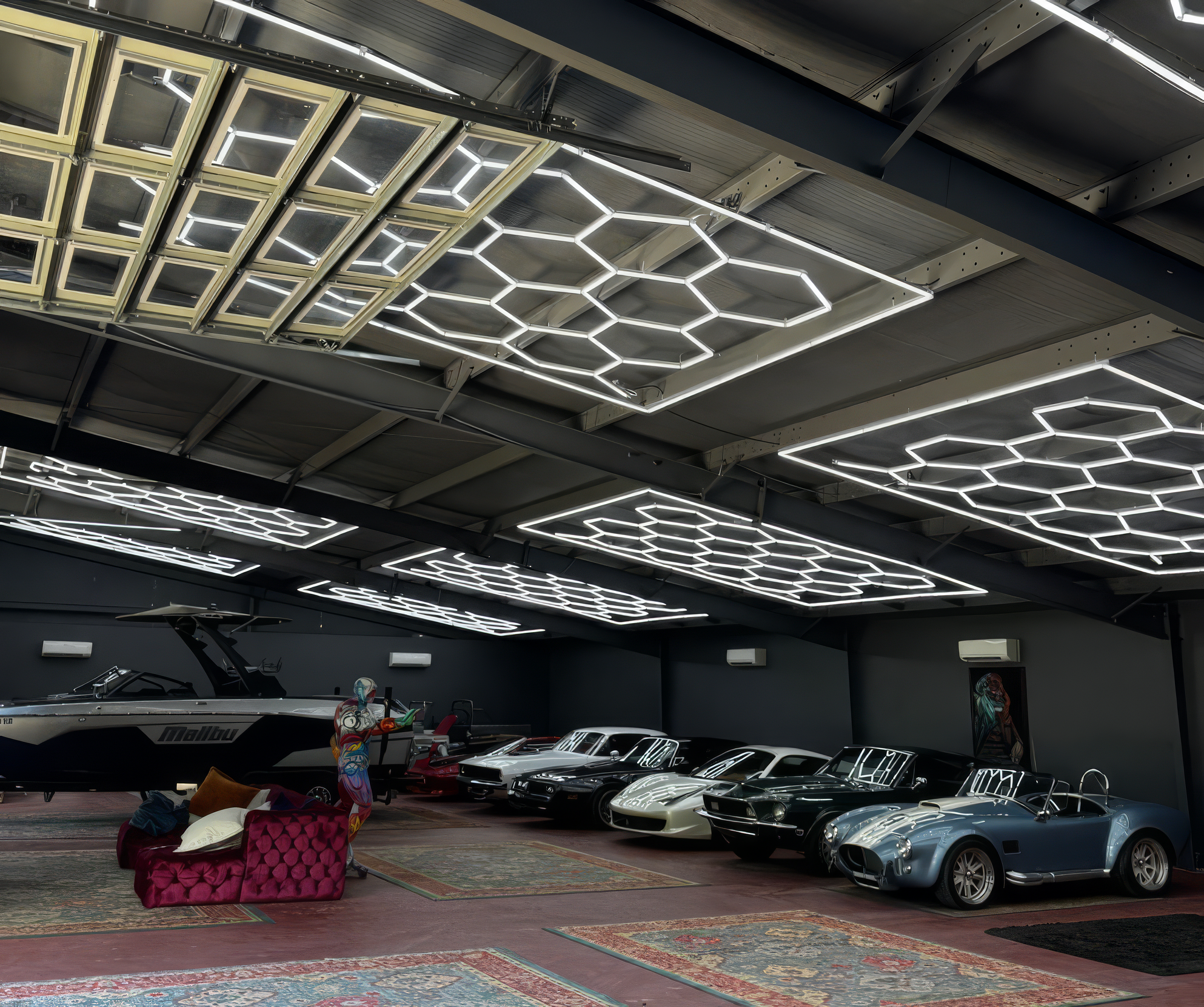 Garage interior with vintage cars and modern lighting fixtures.