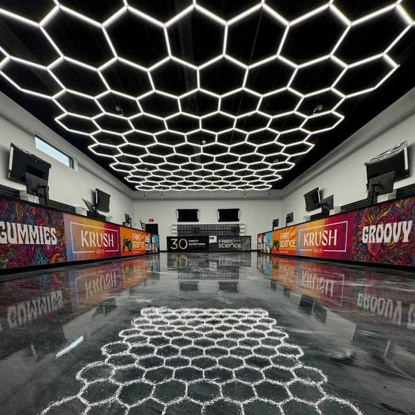 Hexagon garage lighting installed in  dispensary with black ceiling and epoxy floors